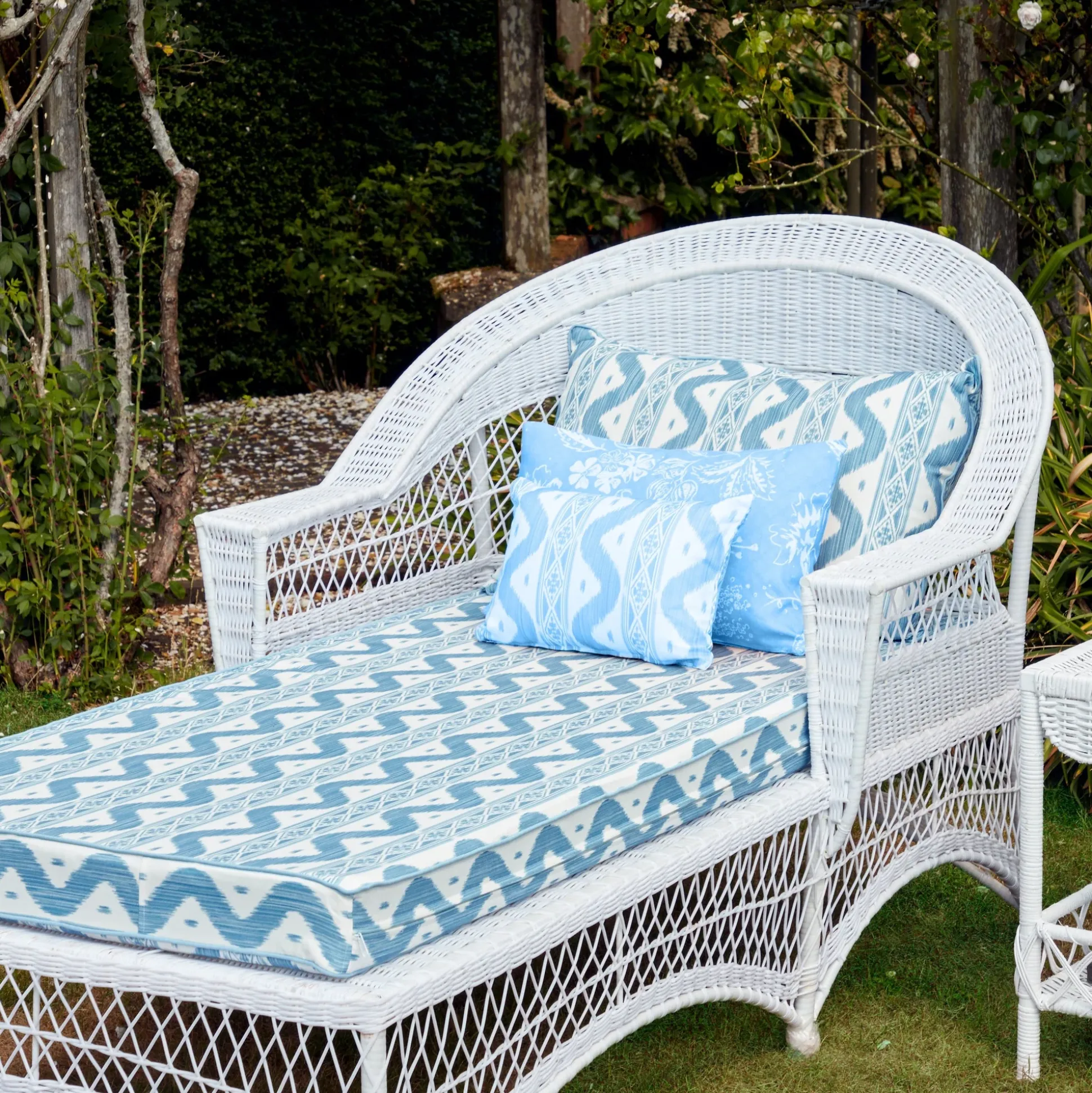 White Rattan Sun Lounger With Blue Ikat Cushion